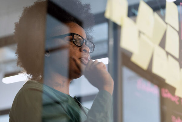 African American businesswoman looking at Post-it notes