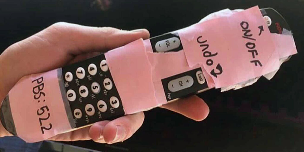 A "grandparent-friendly" remote control with unneeded buttons covered by tape. 
