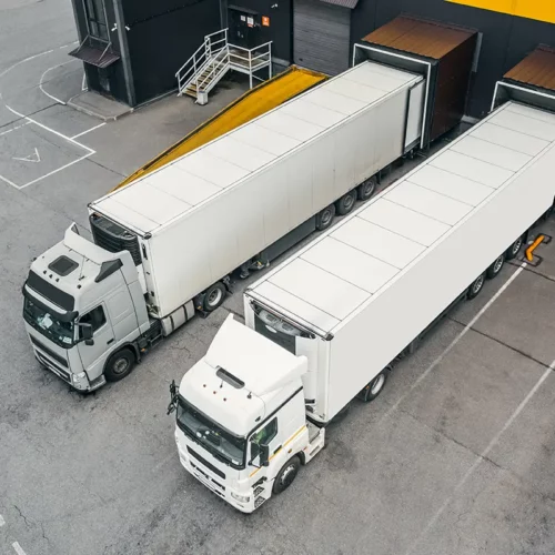 Shipping trucks in a transportation and logistics distribution hub.