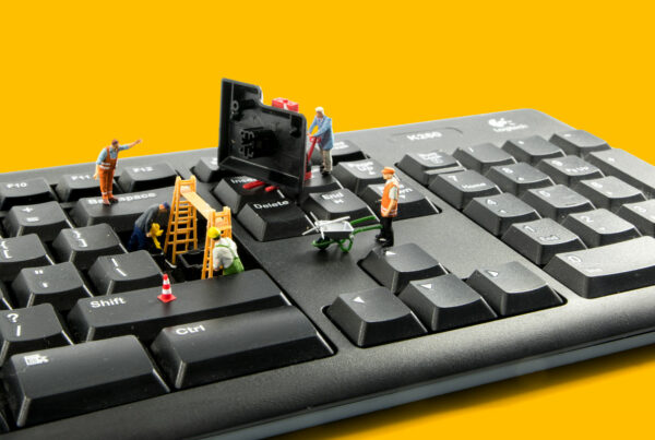 Miniature figures make construction repairs to a keyboard.