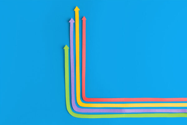 A graphic with multiple colorful arrows pointing upwards on a bright blue background, symbolizing the upward trajectory and growth that an effective application modernization strategy can bring to a business.