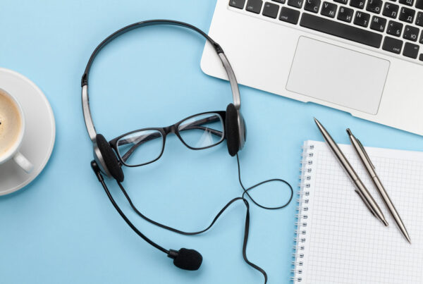 Photo of a headset on a pair of glasses illustrates involving business users in the ERP support workflow.